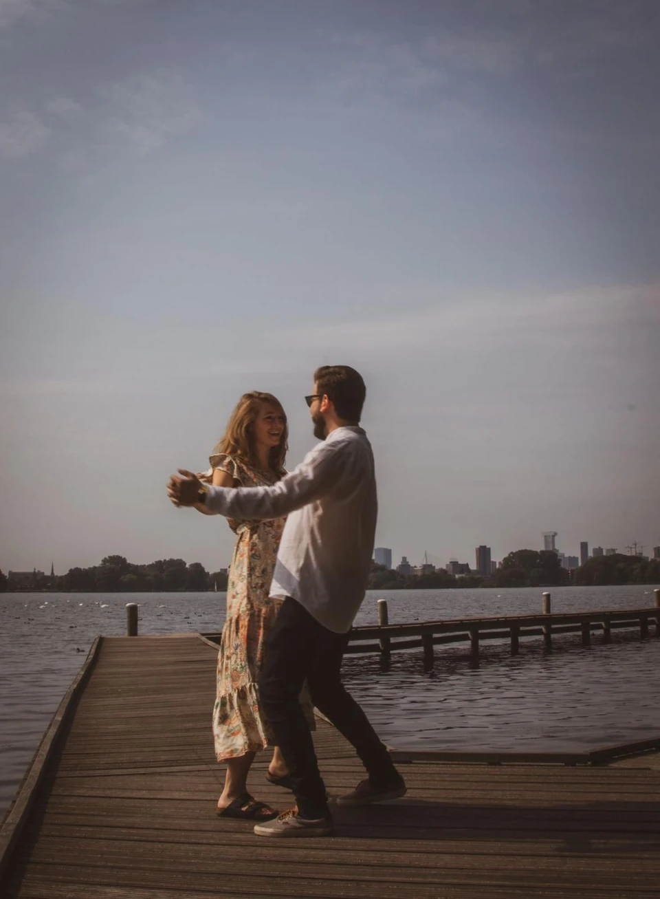 Lisa and Chris dancing on a lakeside pier